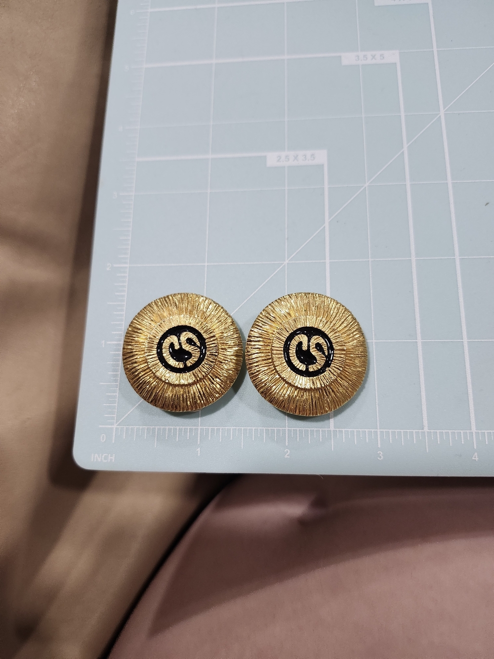 St. John Gold-Tone Textured Round Clip Earrings with Black Logo